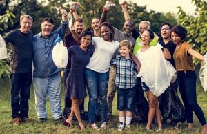 A group of people cheering and cleaning