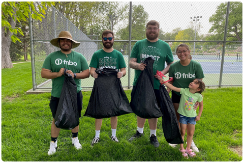 Group pf folks cleaning up litter in a park. 