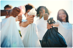 Thumbs up teenagers picking up litter