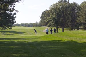 Four golfers on the fairway at Woodland Hills Golf Course during the Keep Nebraska Beautiful Golf for the Environment Tournament